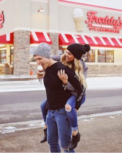 A couple enjoying a Freddy's waffle cone