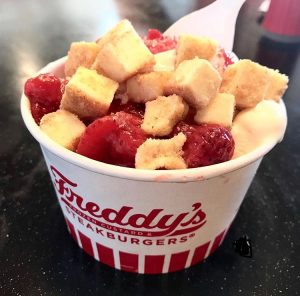 Freddy's vanilla sundae with strawberry and cheesecake topping